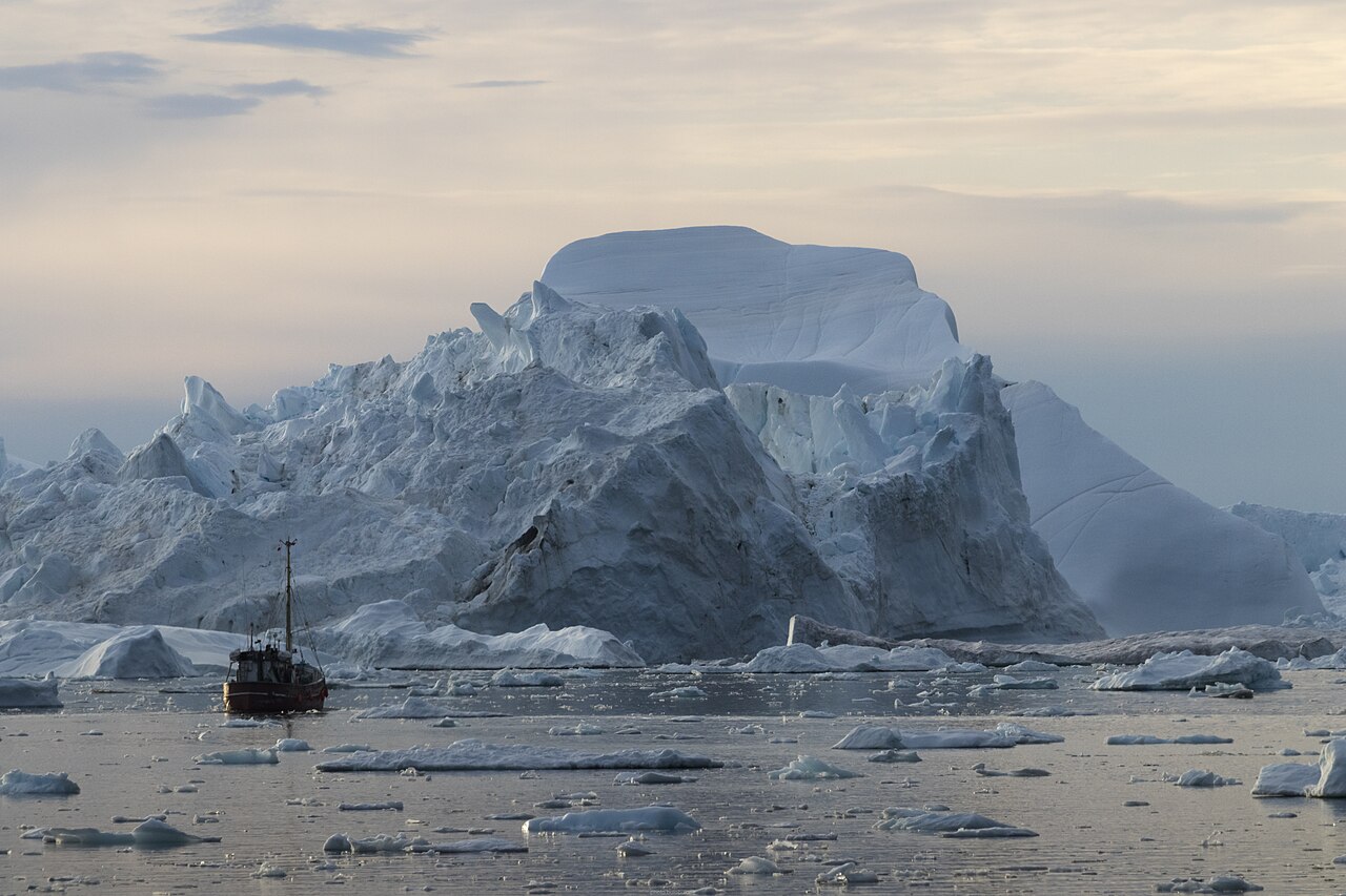 Icebergs and a small boat in Disko Bay, Greenland